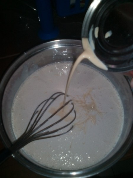 adding evaporated milk to bowl