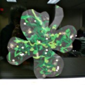 A completed photo of a shamrock suncatcher made from clear contact paper.