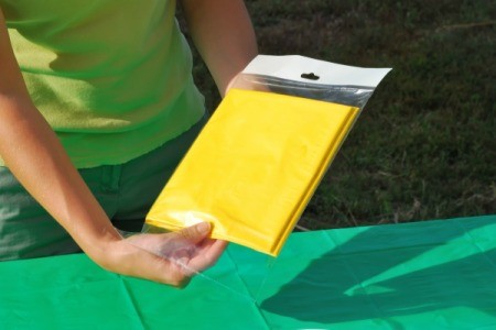 A packaged yellow plastic tablecloth.