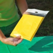 A packaged yellow plastic tablecloth.