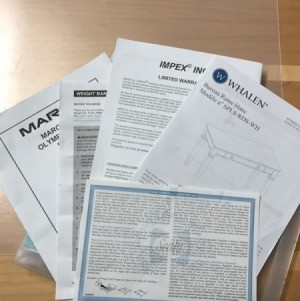 A bunch of warranty documents on a clear case.