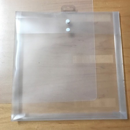 A clear plastic folder on a wood surface.