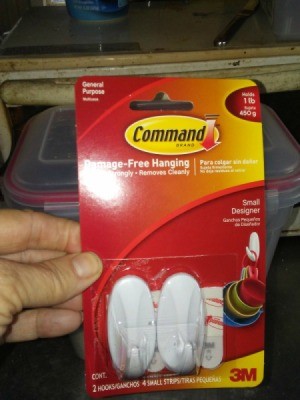 A package of Command plastic hooks.