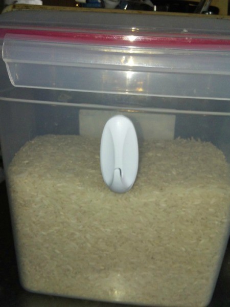 A plastic hook attached to a container of rice.
