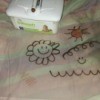 Children's drawings on a clear flexible cutting mat.