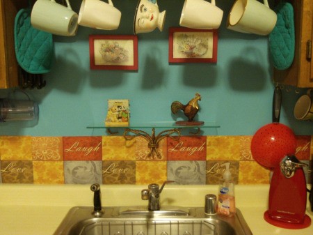 DIY Backsplash - aqua wall behind sink with the placemats cut in half and mounted behind sink
