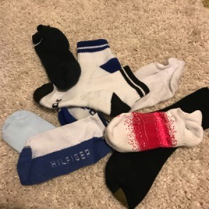 A pile of mismatched socks on the floor.