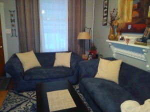 Curtain and Accent Pillow Color Advice - blue couch with curtains in background and pillow on couch