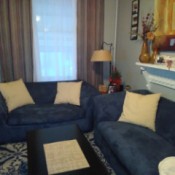 Curtain and Accent Pillow Color Advice - blue couch with curtains in background and pillow on couch