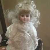 Value of Porcelain Doll - doll wearing a white lace dress