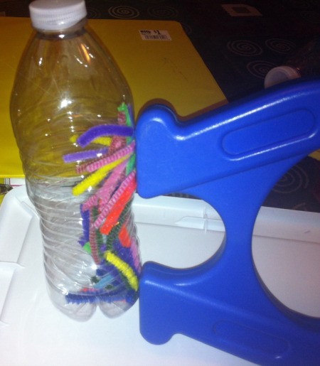 Magnetic Discovery Bottles - magnet against bottler with pipe cleaner bits