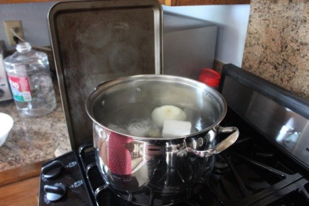 Homemade pho broth in a stockpot.