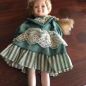 Identifying Doll Manufacturer - small doll with blond hair and green and white dress