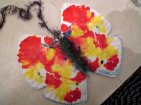 Make a Spring Butterfly from a Paper Plate - wrap yarn around the center fold for the body