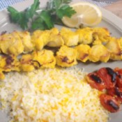 Chicken Kabobs, tomatoes and rice on plate