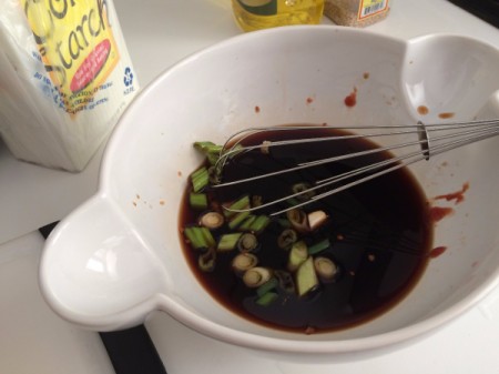 A sauce being whisked for the simmered chicken.