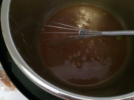 Sauce in the bottom of the pressure cooker.