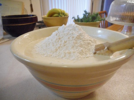 Flour on top of a bread dough mixture.