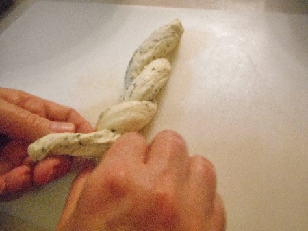 Twisting dough to make a loaf.