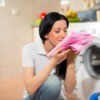 A woman smelling fresh laundry.