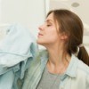 A woman smelling fresh laundry.