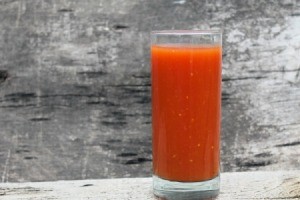 A tall glass of tomato juice.