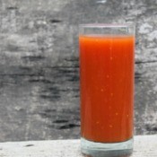 A tall glass of tomato juice.