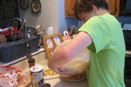 Adding apples to pie crust.