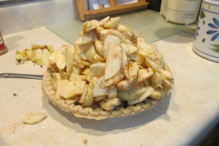 Apples mounded over bottom pie crust.