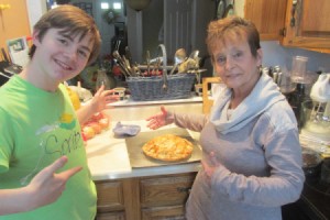 A grandmother and grandson proudly showing off their Pi Day pie.