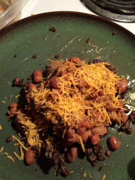 cheese sprinkled on beans and ground beef