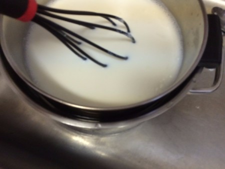 whisking milk in pan