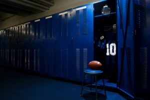 A football locker room with blue lockers.