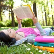 A woman reading books in the summer.