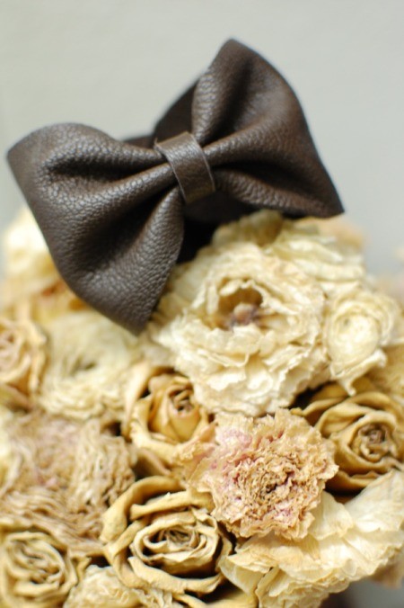 DIY Leather Bow Bracelet - bracelet on bouquet of dried roses