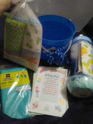 The contents of a baby shower gift, placed in a reusable pail.
