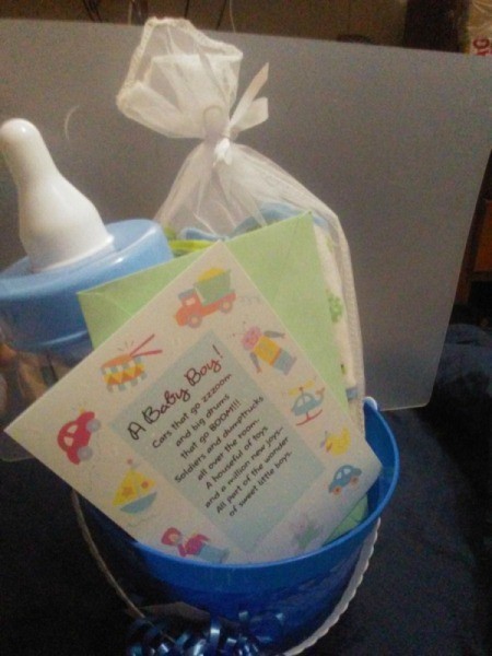 The contents of a baby shower gift, placed in a reusable pail.