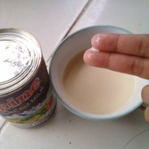 A bowl of evaporated milk for use on a woman's skin.