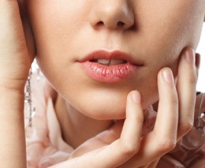 Chapped lips wearing lipstick.