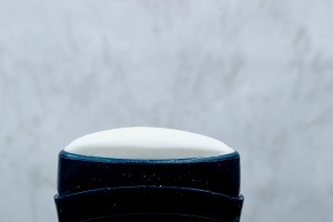 A white stick deodorant with the lid off.