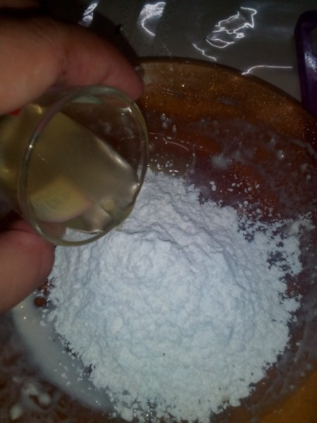 adding oil to flour for dough