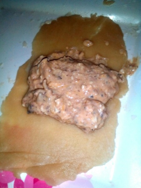 filling on dough ready to roll up