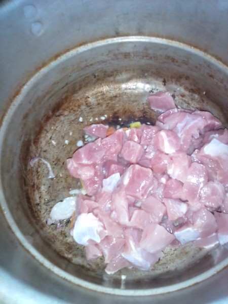 adding pork to onion and garlic