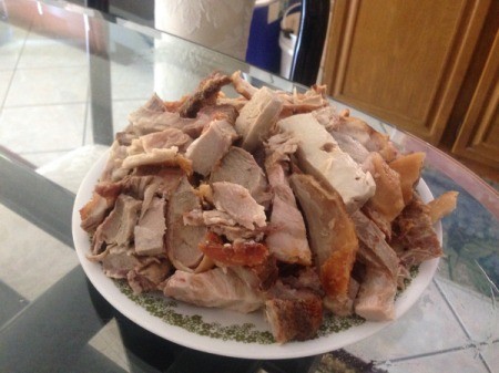 A plate of roasted pork belly in pieces.