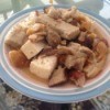 A plate of tofu and pork belly stir fry.