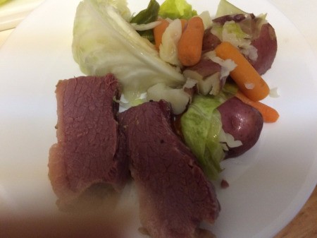 A plate of corned beef and cabbage.