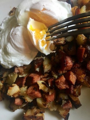 A plate of corned beef hash and eggs.