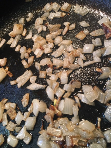 Onions being cooked for corned beef hash.