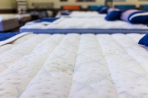A row of mattresses in a store.