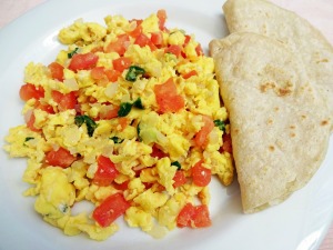 An omelette with tomatoes and herbs.